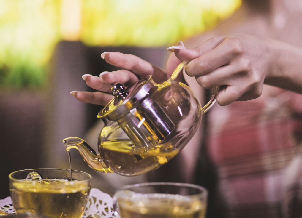 woman is pouring tea.