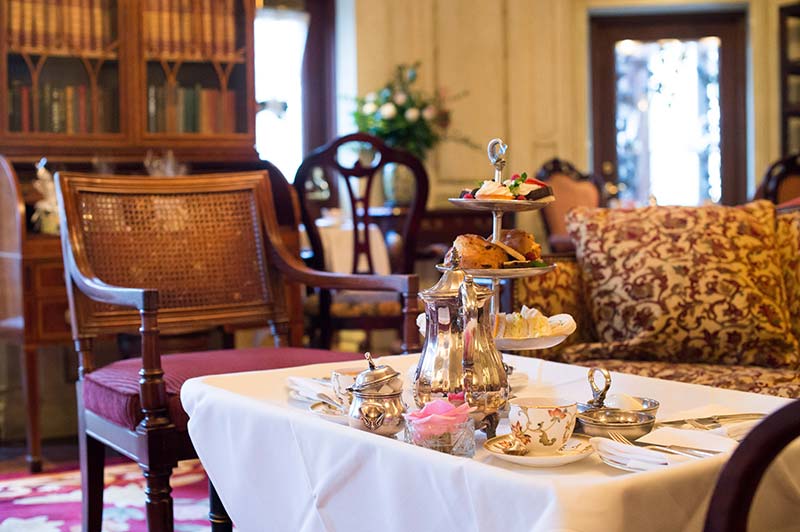 A laid table with various delicacies on the background of old furniture